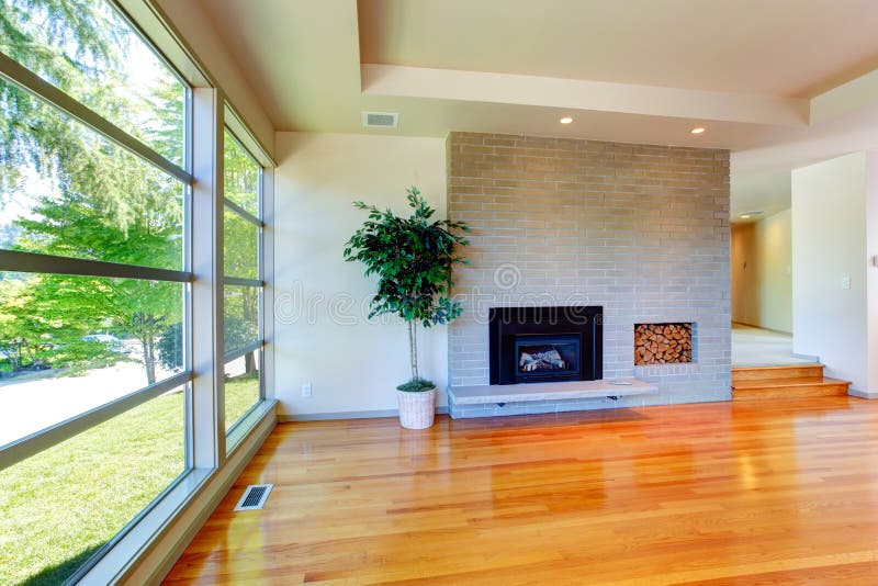 Empty house interior. Glass wall living room with brick wall an