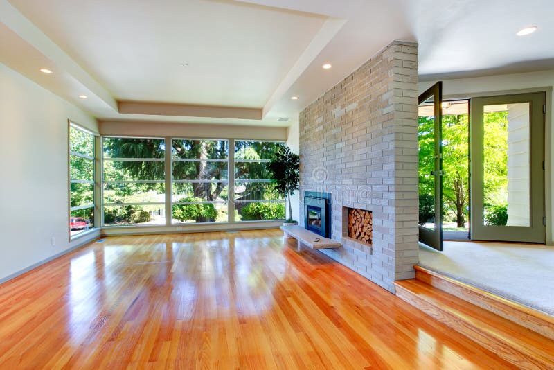 Empty house interior. Living room with glass wall and brick wall