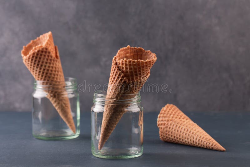 https://thumbs.dreamstime.com/b/empty-ice-cream-cone-blue-background-space-text-several-glass-jar-grey-94259420.jpg