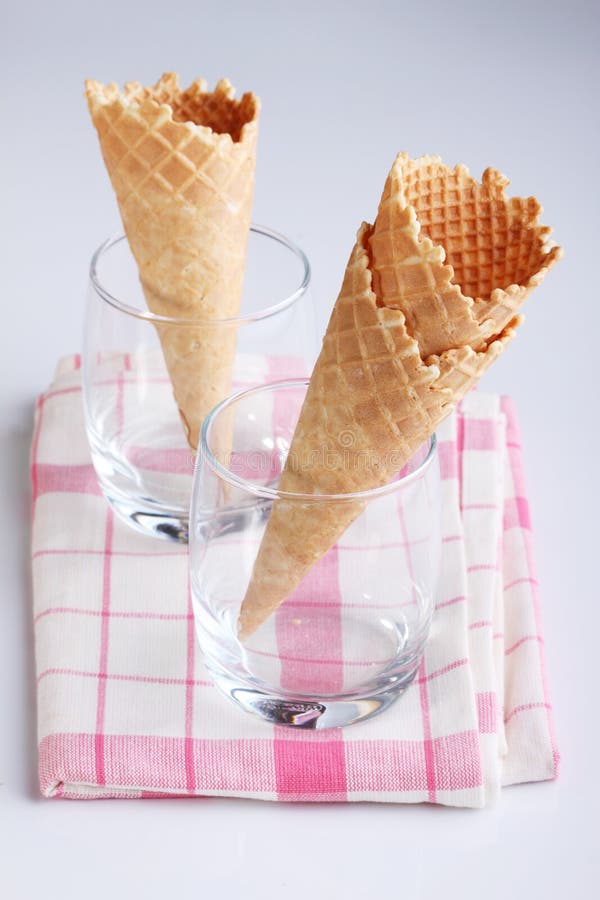 Empty Ice Cream Cones in Clear Glasses on Pink Fabric Stock Photo