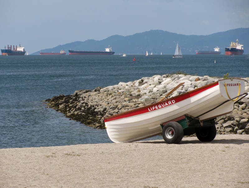 row boat moored near shore. ripple lake water. boat rental