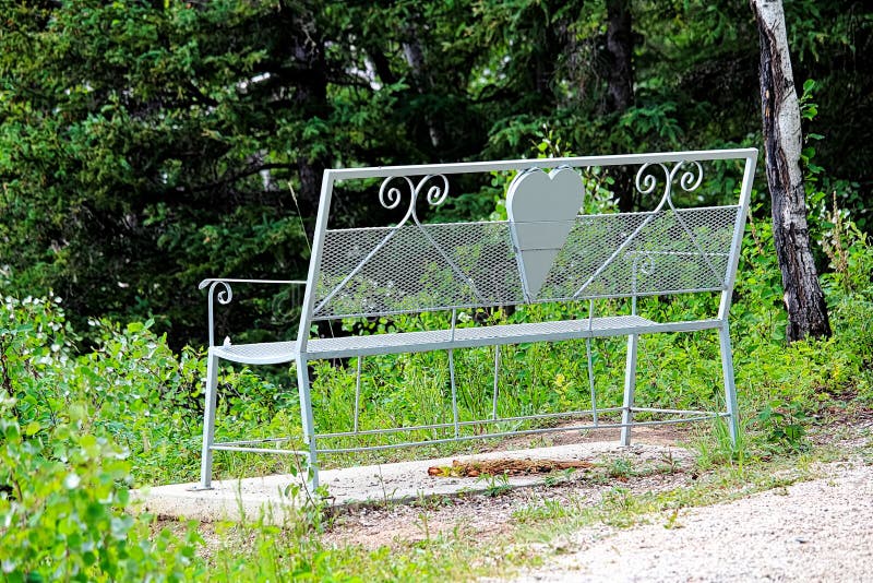 An empty lovers bench on hiking trail path royalty free stock photo An empty lovers bench on hiking trail path royalty free stock photo