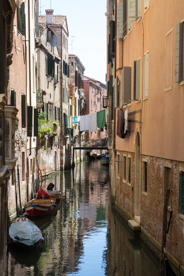 Narrow canal in Venice with moored gondolas and facades of old houses stock photo Narrow canal in Venice with moored gondolas and facades of old houses stock photo
