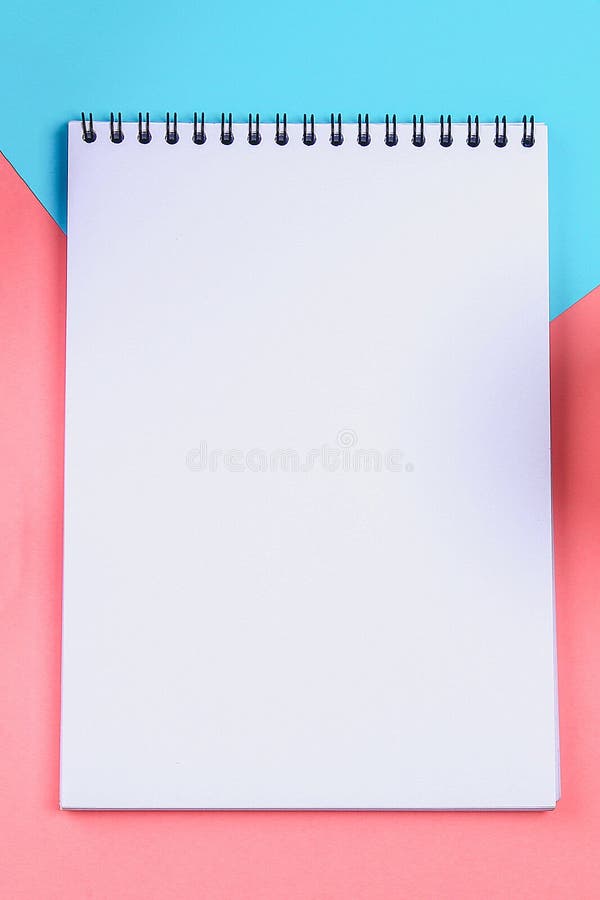 Empty Notebook with a Blue Pen on a Yellow Pastel Background. Mockup