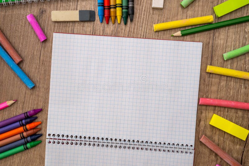 Empty notepad with color chalks and pencils stock photos Empty notepad with color chalks and pencils stock photos