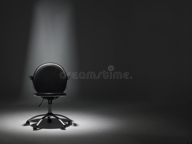 Empty Black Office Chair In Spotlight. Empty Black Office Chair In Spotlight