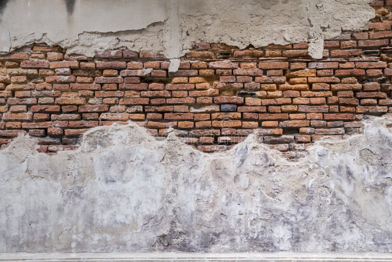 Empty Old Brick Wall Texture. walls disintegration see red brick. Building Facade With Damaged Plaster