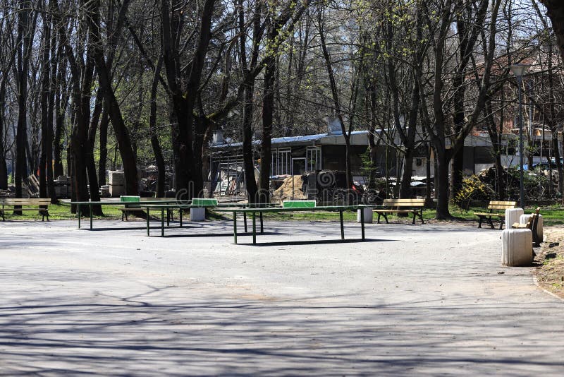 Empty park with empty benches as prevention from coronavirus Covid-19 disease. Closed park for restriction during quarantine stock images