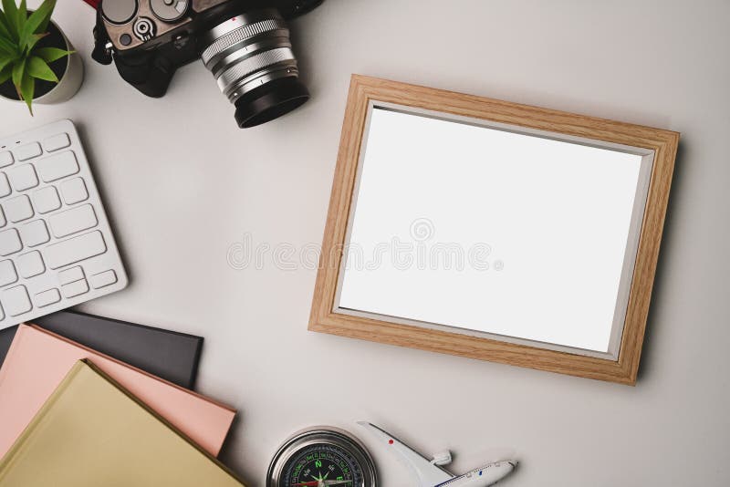 Photo Frame, Camera and Notebook on Photographer Workspace. Stock Photo