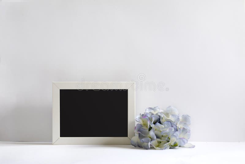 Empty picture frame, decorated with blueflowers