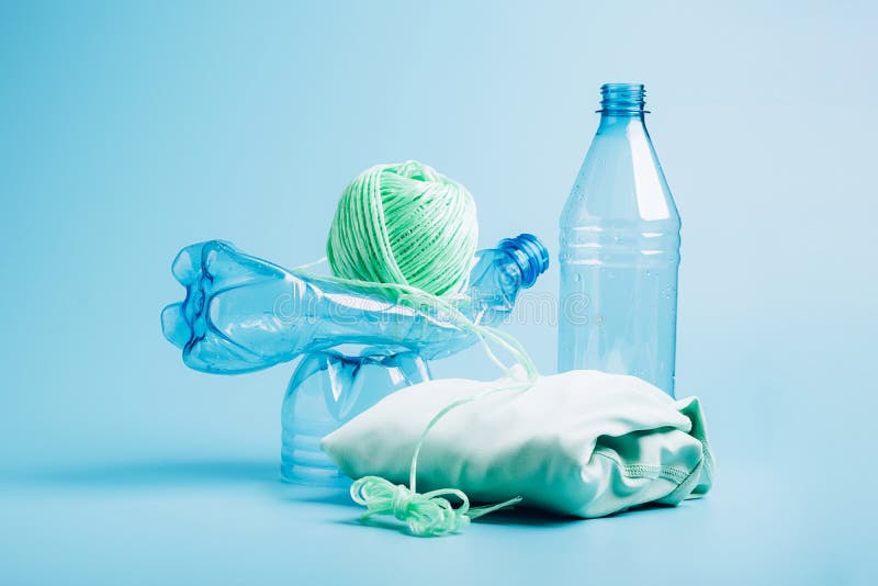 Empty Plastic Bottle and Various Fabrics Made of Recycled Polyester