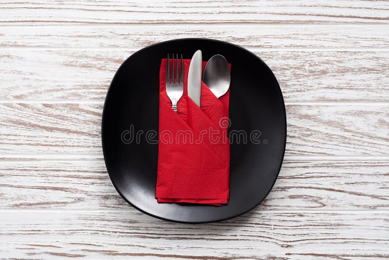 Empty plate napkin fork knife silverware white wooden table background royalty free stock photos