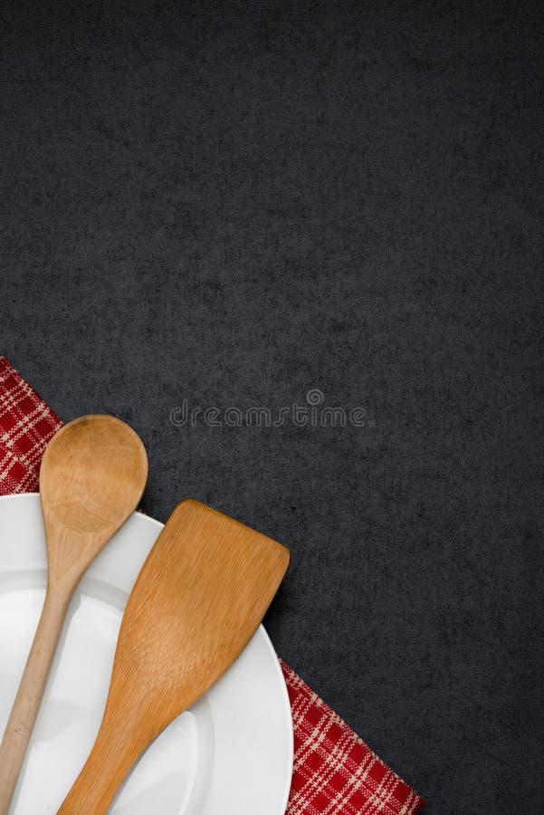 Empty plate and spoon in the corner on a blackboard