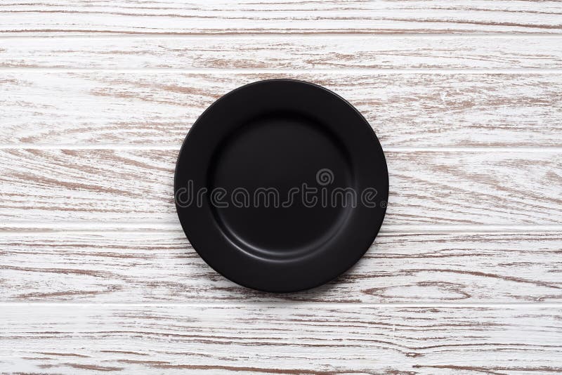 Empty plate on white wooden table background flat lay stock images