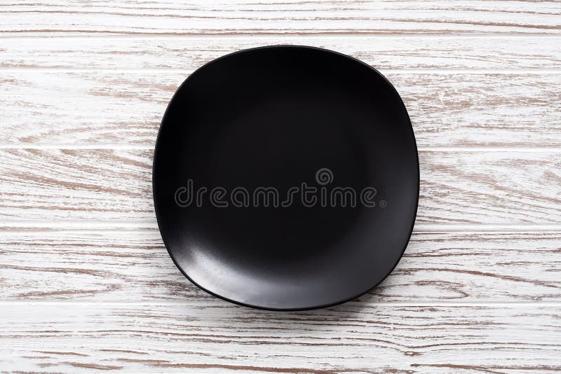 Empty plate on white wooden table background flat lay royalty free stock photo