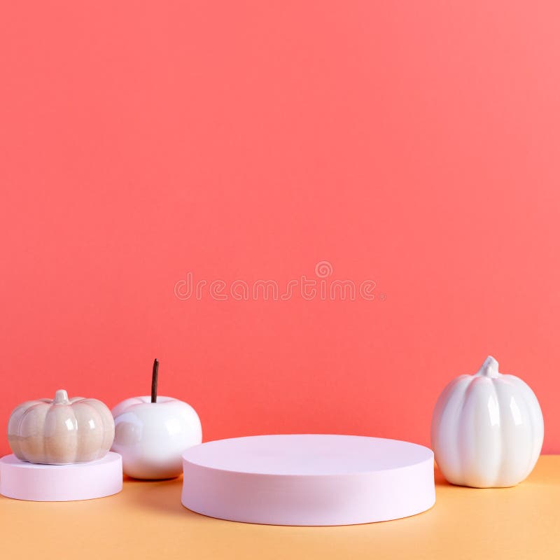 Empty product podium with autumn pumpkin decor in pastel pink and orange colors