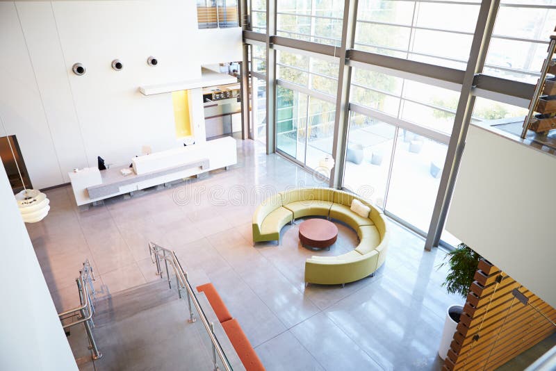 Empty Reception Area In Modern Office With Round Sofa