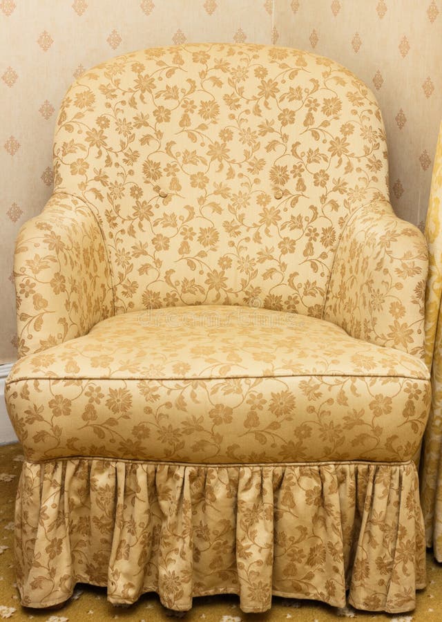 Empty retro brown armchair with floral pattern