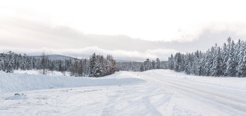 Empty road with huge snow banks on sides on cloudy winter day. Empty road with huge snow banks on sides on cloudy winter day