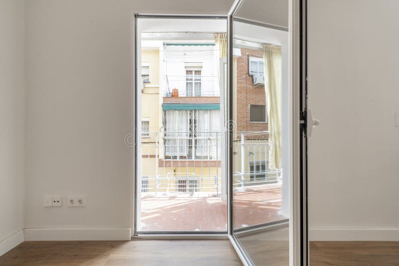 An empty room with access to a small terrace with views stock photos