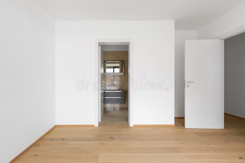 Empty room with attached marble bathroom