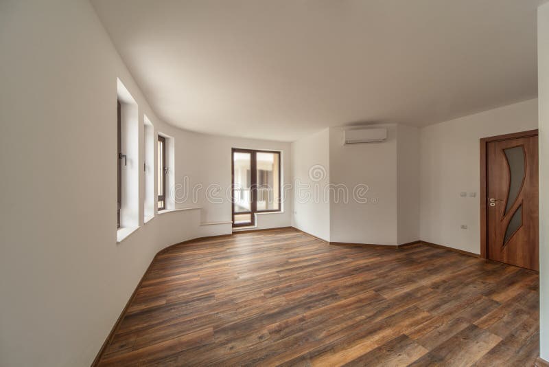 Empty room with natural light from windows.Modern house interior. Wooden floor.