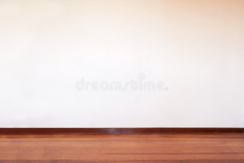 Empty room with wooden floor and blank wall in a country house