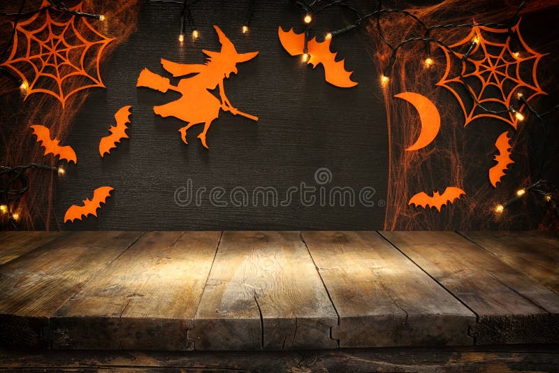 Empty rustic table in front of Halloween holiday background. Ready for product display montage