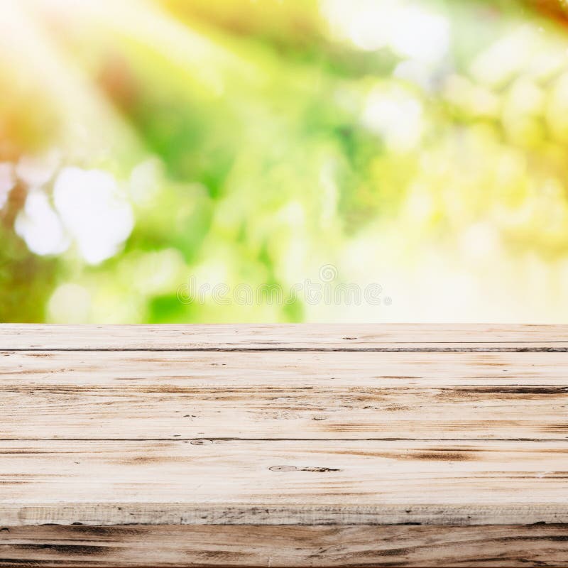 Empty rustic wooden table with golden sunlight stock photo