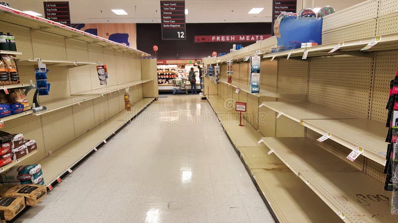 Empty shelves of toilet paper in a grocery store