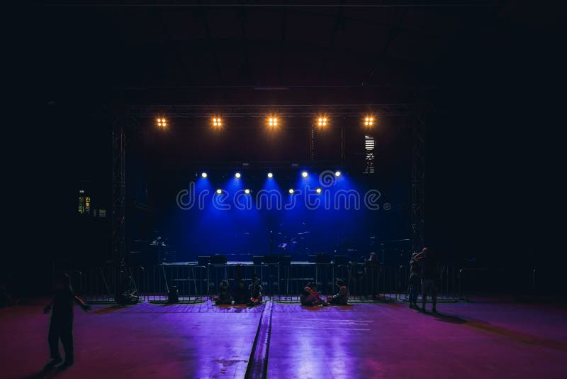 Empty Stage with Blue Lights and Audience Waiting for the Show To Start ...