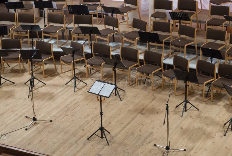 Empty Stage with Chairs, Microphones and Music Stands before the Stock