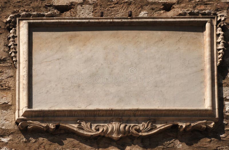 Empty stone tablet with modelling on old wall