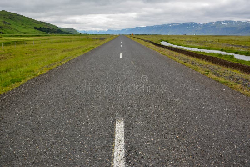 Empty straight asphalt road with view to mountains