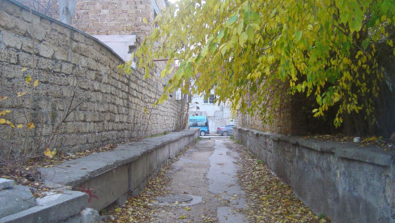 Empty the straight,narrow lane between brick walls in the Old town, on a cloudy day stock photos Empty the straight,narrow lane between brick walls in the Old town, on a cloudy day stock photos