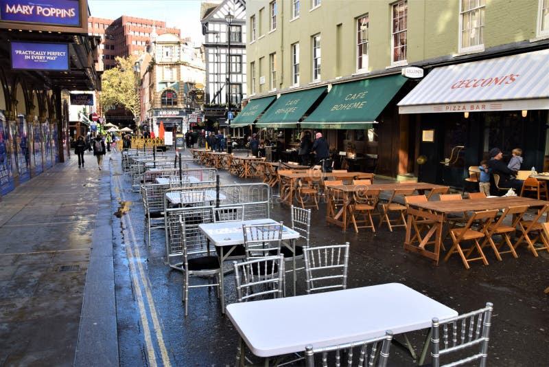 Empty outdoor tables awaiting customers in Soho, London