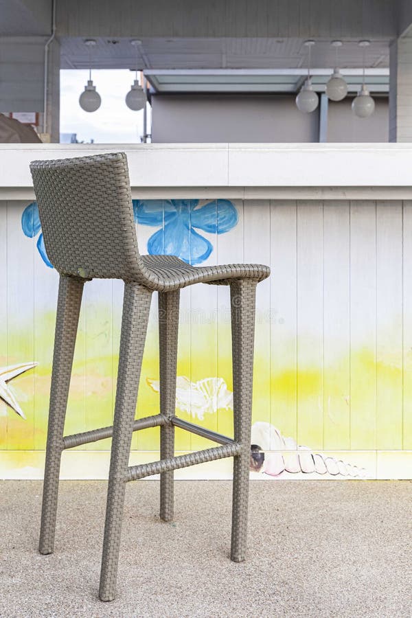 Tall Plastic Rattan Chair Placed at the Bar Counter by the Sea Stock