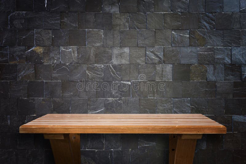 Empty top wooden shelves and stone wall background