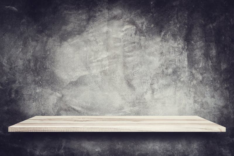 Empty top wooden shelves and stone wall background