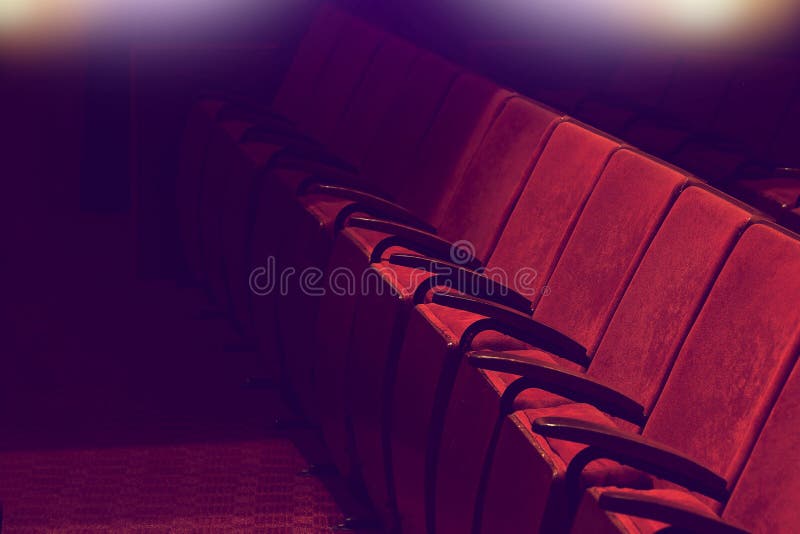 Empty vintage red seats in theater auditorium