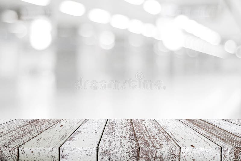 Empty vintage white wood table over blur store background, perspective wooden board background for product and food display stock images