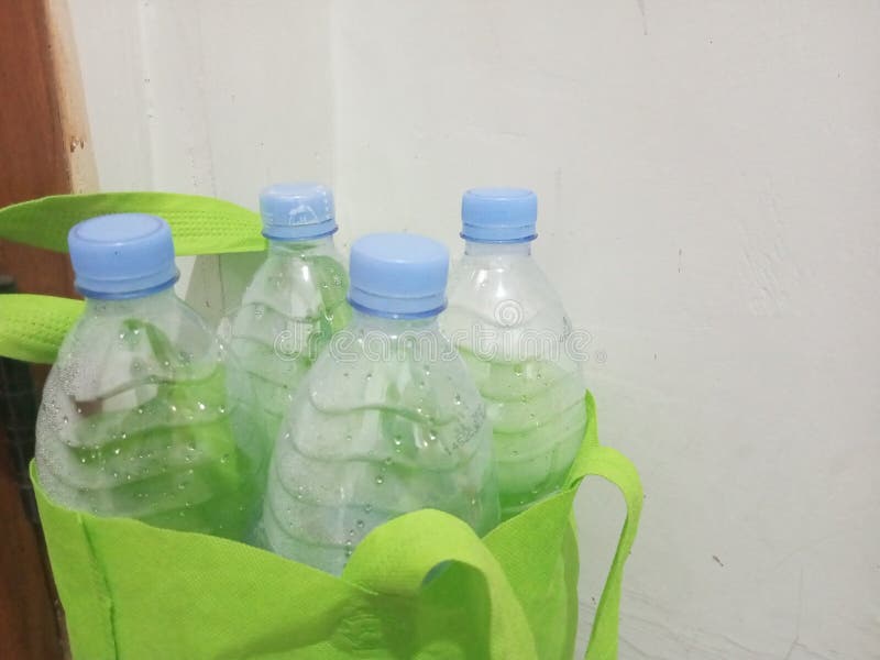 Empty Water Bottle Inside Light Green Tote Bag stock images
