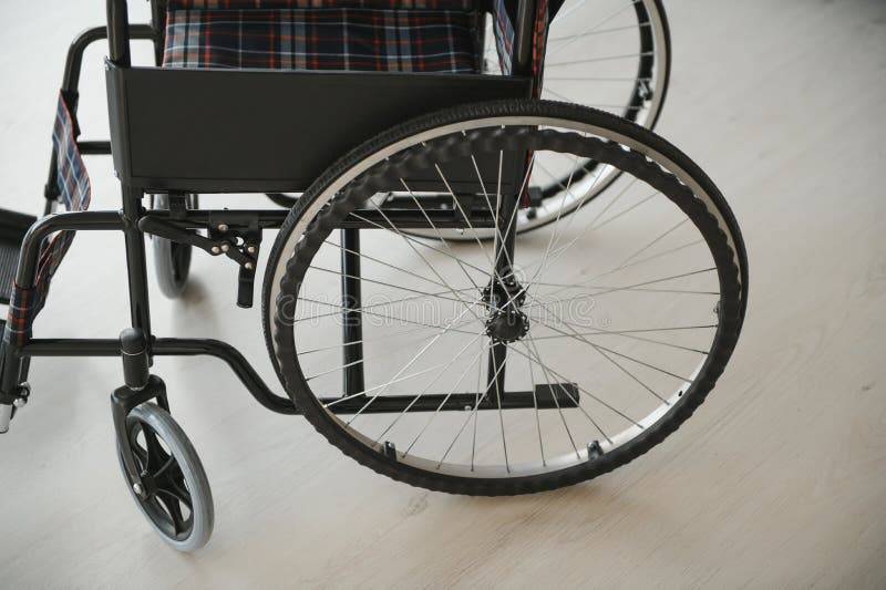 Empty Wheelchair in Living Room Next To the Couch Stock Photo Image