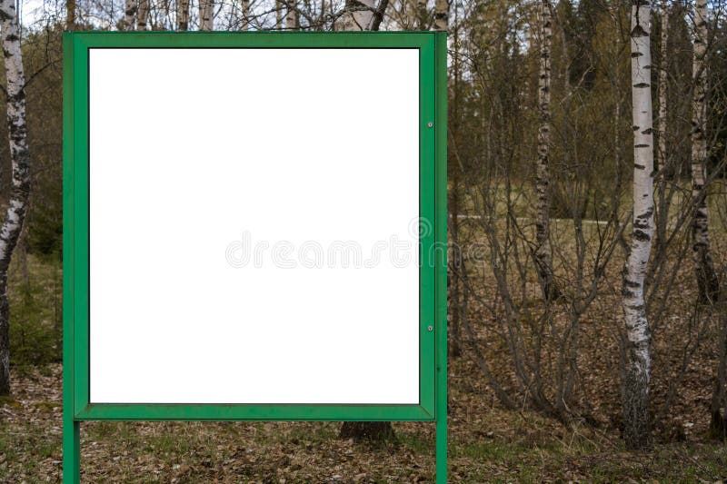 Empty white billboard with green frame and nature background royalty free stock images