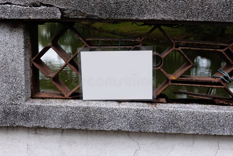 An empty white laminated sign attached to a bridge royalty free stock photo