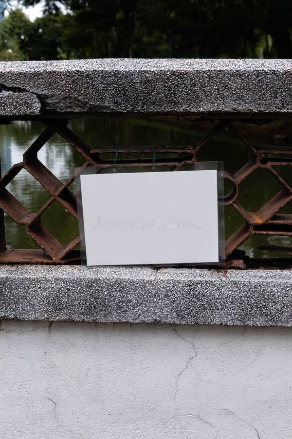 An empty white laminated sign attached to a bridge royalty free stock photo