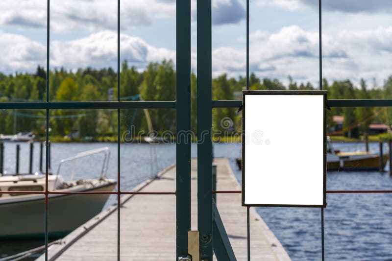 Empty white note on a metal gate in harbor royalty free stock photos