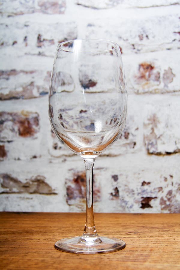 Empty wine glass against a rustic background royalty free stock image