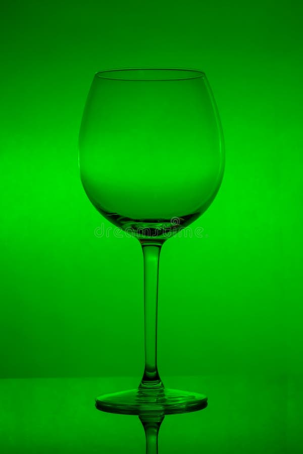 Empty Wine Glass on Green Background, Empty Wineglass Stock Image