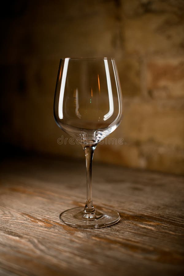 Empty Wine Glass on a High Leg on Brown Background Stock Photo Image